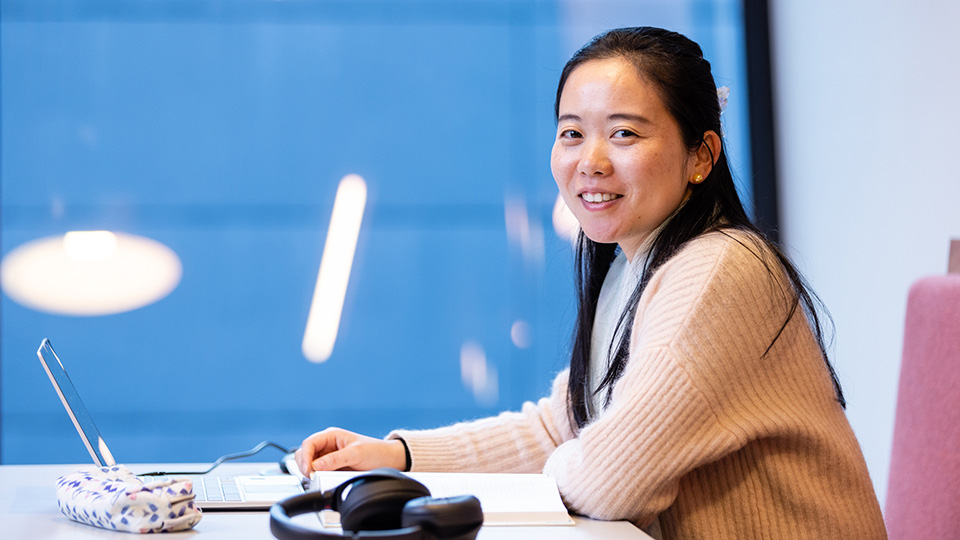 Female student studying with her laptop at VU City Tower.