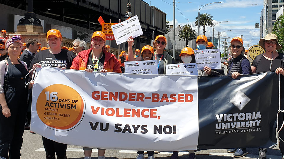 VU staff marching with banner for the 'Walk against family violence' as part of 16 Days of Activism.