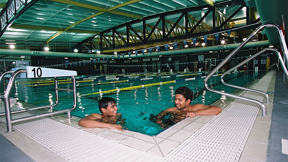 Two people swimming in the pool at Footscray Park Fitness & Aquatic Centre