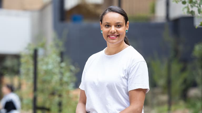 VU student standing outdoors and smiling on Footscray Park campus