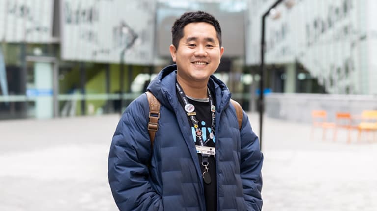 VU student standing outdoors and smiling on Footscray Park campus