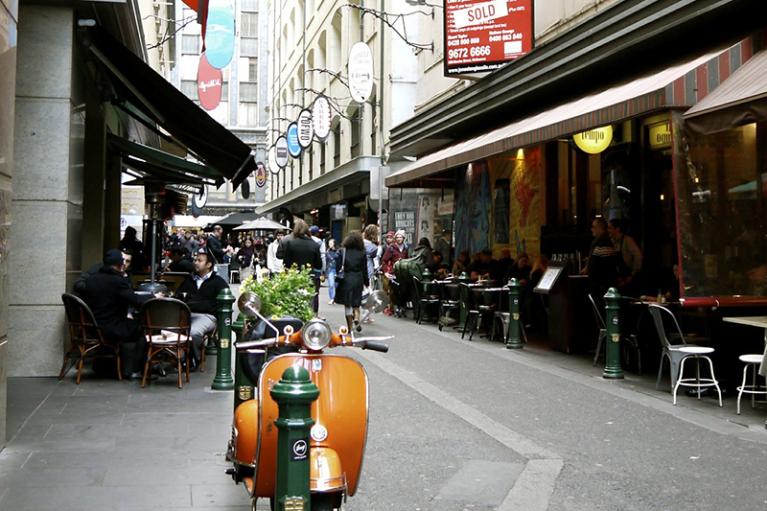 An orange scooter parked in Melbourne's Degraves Street.