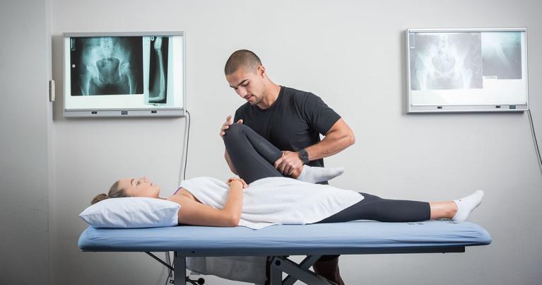 Osteo student works on patient.