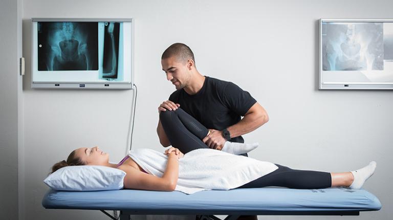 An osteopathy student treating a client in the clinic.