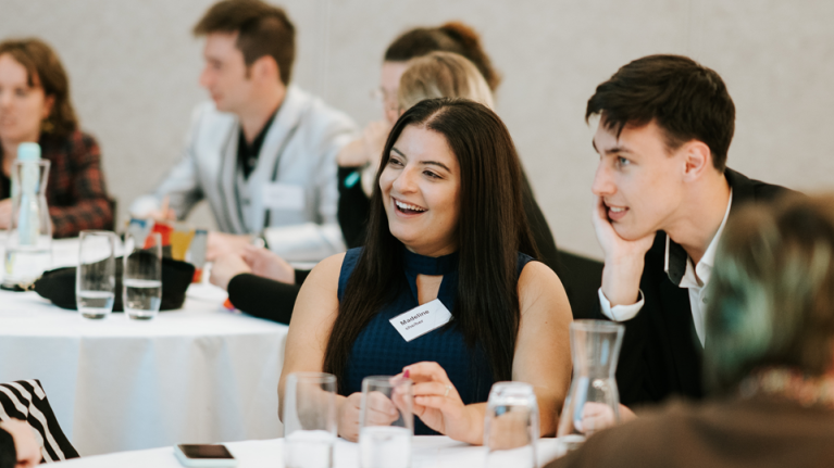 Student leaders interacting at tables at the Student Leadership Conference