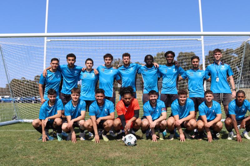 Mens football (soccer) team gather for a team shot in front of the goals at UniSport Nationals 2024