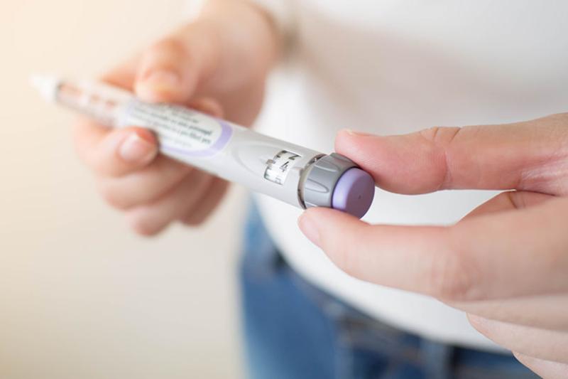 Person holding insulin in their hands.