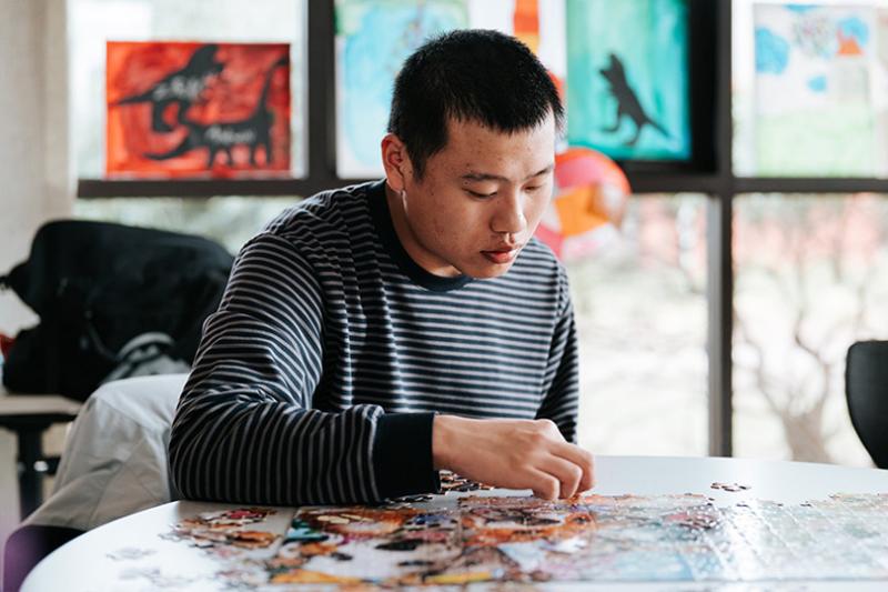 David Yong completing a puzzle