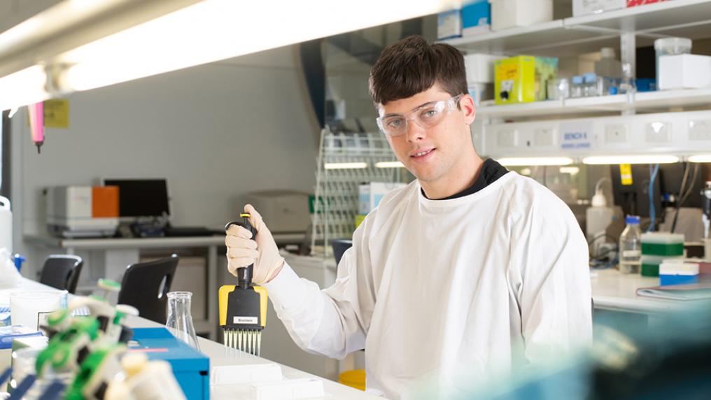Cody Thomson conducting research in a lab