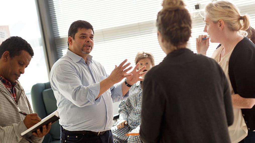 teacher surrounded by students during a simulated session