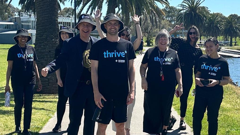 A group of thrive* participants walking by the Maribyrnong on a sunny day.