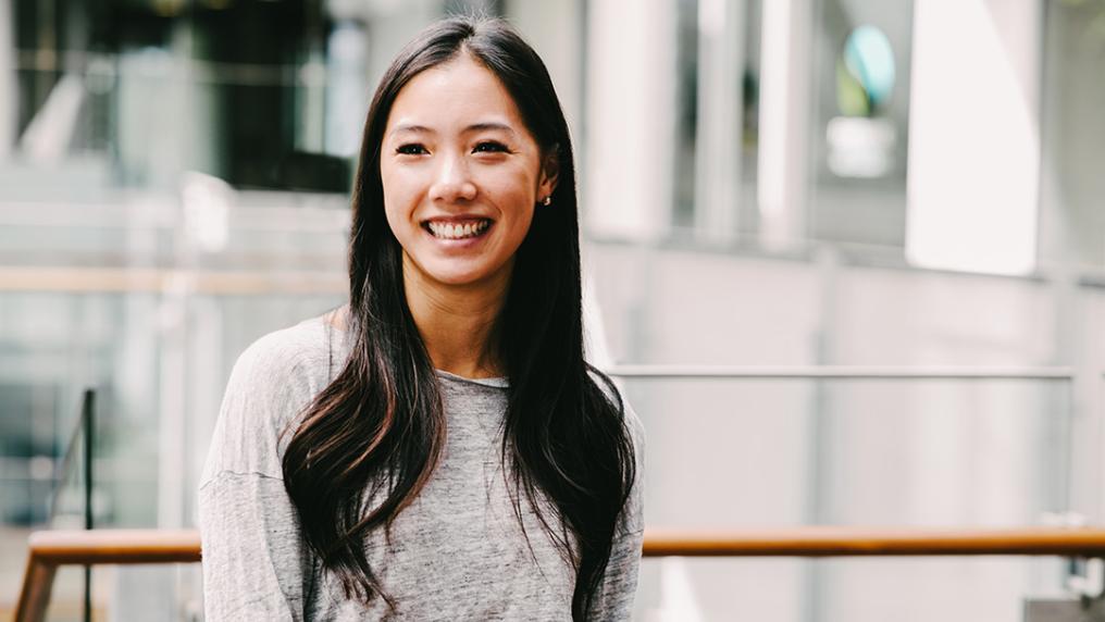 A young woman in professional dress in a modern office building