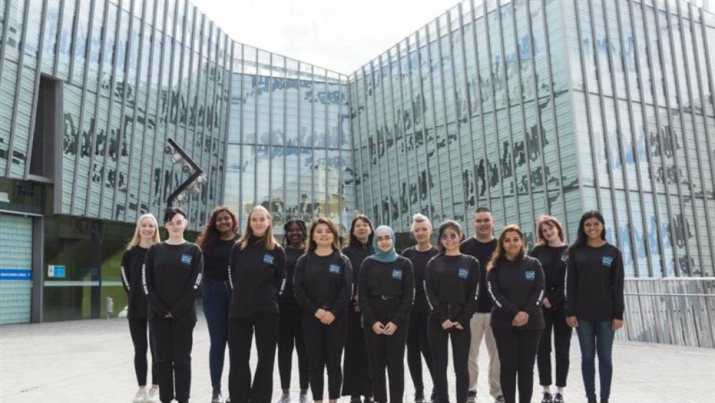 A group of Student Mentors stand together in the courtyard outside M building on VU's Footscray Park campus.