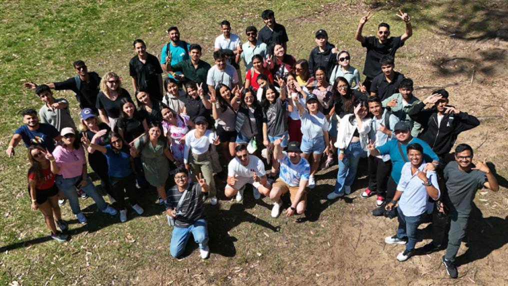 A large group of students standing outside and posing for the camera.