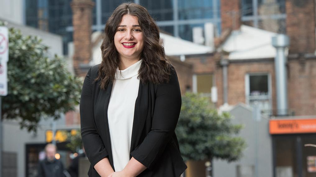 Young woman in modern, professional clothing in a trendy city environment